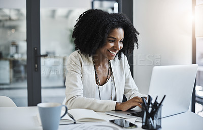 Buy stock photo Shot of a young businesswoman working and in good spirits at her office desk