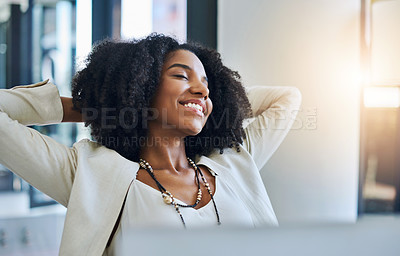 Buy stock photo Shot of a young businesswoman laying back and relaxing at her office desk
