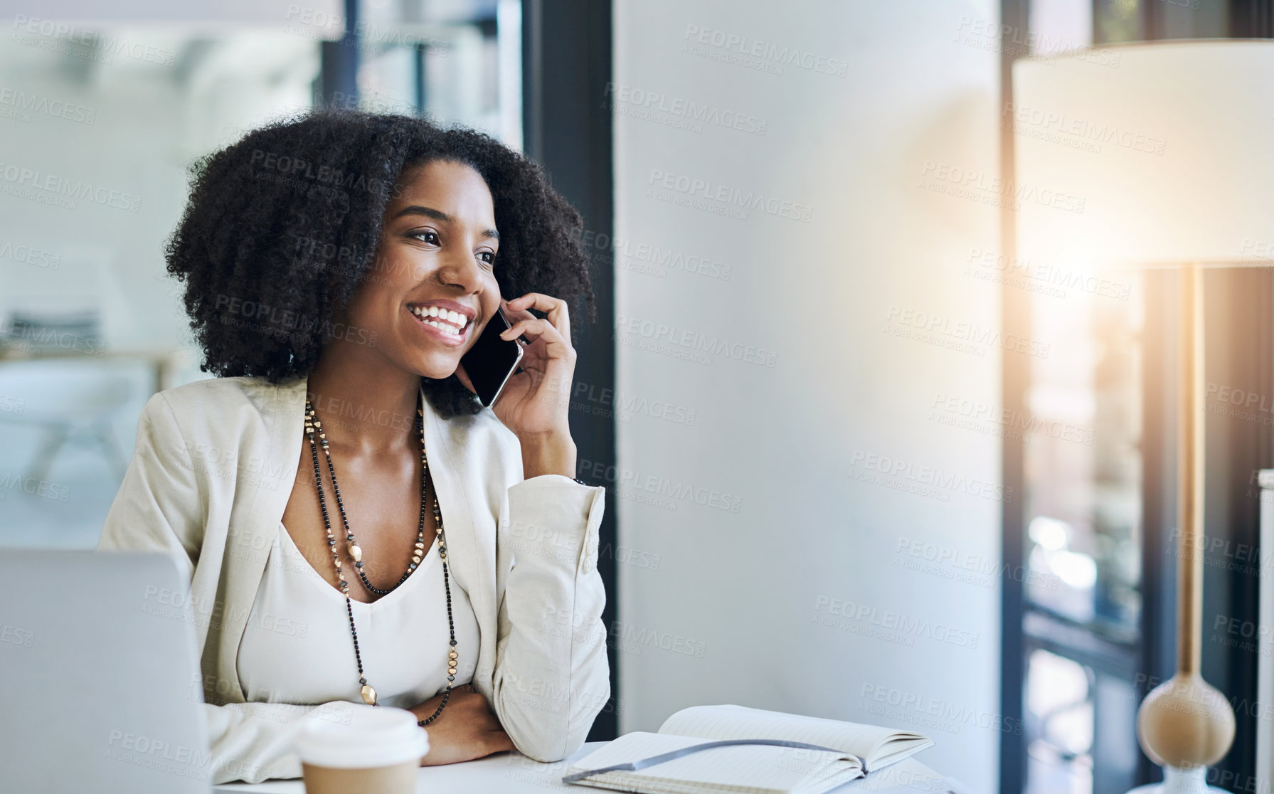 Buy stock photo Shot of a young businesswoman taking a phone call at her office desk