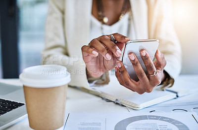 Buy stock photo Shot of an unrecognizable businesswoman using her cellphone at her office desk