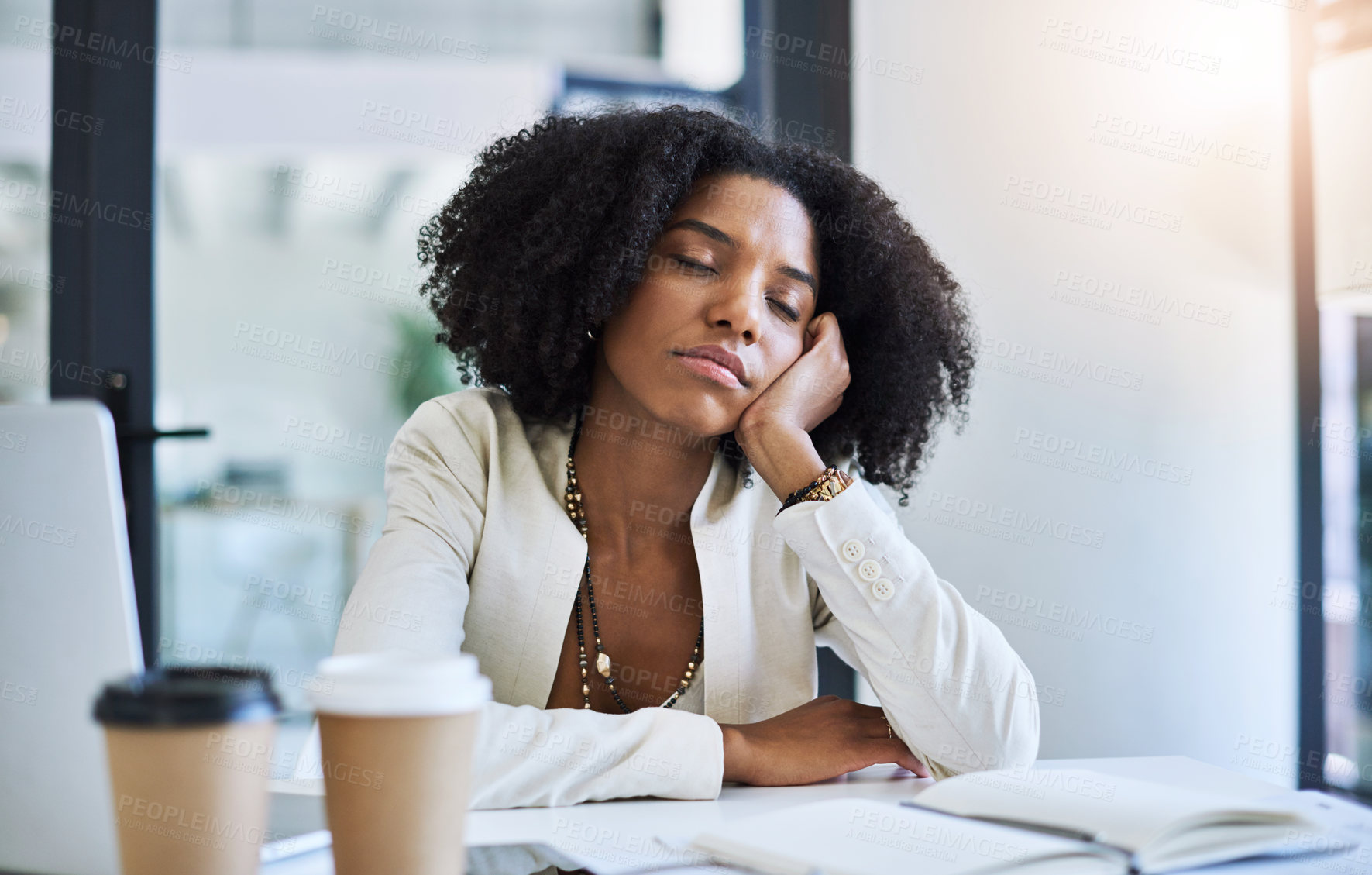 Buy stock photo Shot of a young businesswoman taking a nap at her office desk