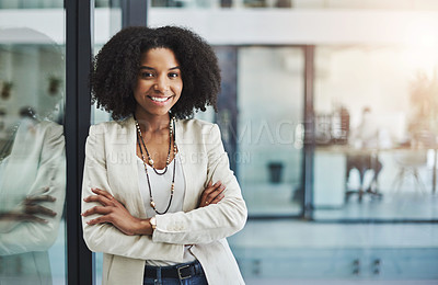 Buy stock photo Portrait of a young businesswoman smiling and posing with her arms folded in her office