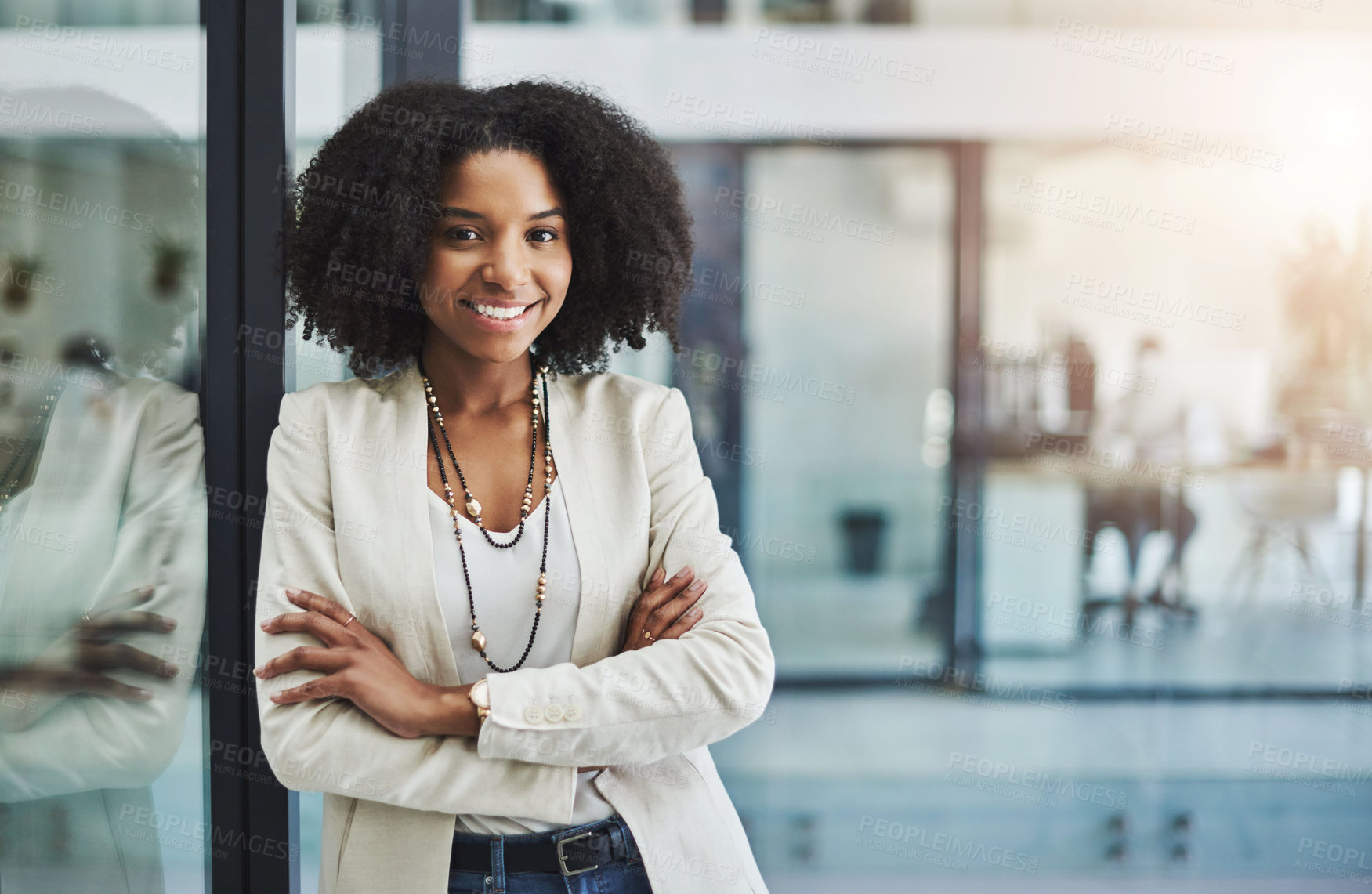 Buy stock photo Portrait of a young businesswoman smiling and posing with her arms folded in her office