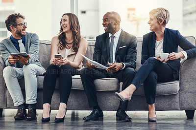Buy stock photo Full length shot of a group of businesspeople brainstorming together in an office