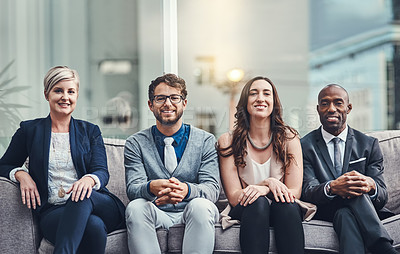 Buy stock photo Cropped portrait of a group of businesspeople sitting on a couch in an office
