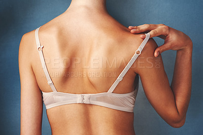 Girl taking off bra, cutting her lingerie with - Stock Photo