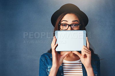 Buy stock photo Portrait, tablet screen and space with a fashion woman in studio on a blue background for social media marketing. Face, display and style with a young person holding technology for advertising mockup