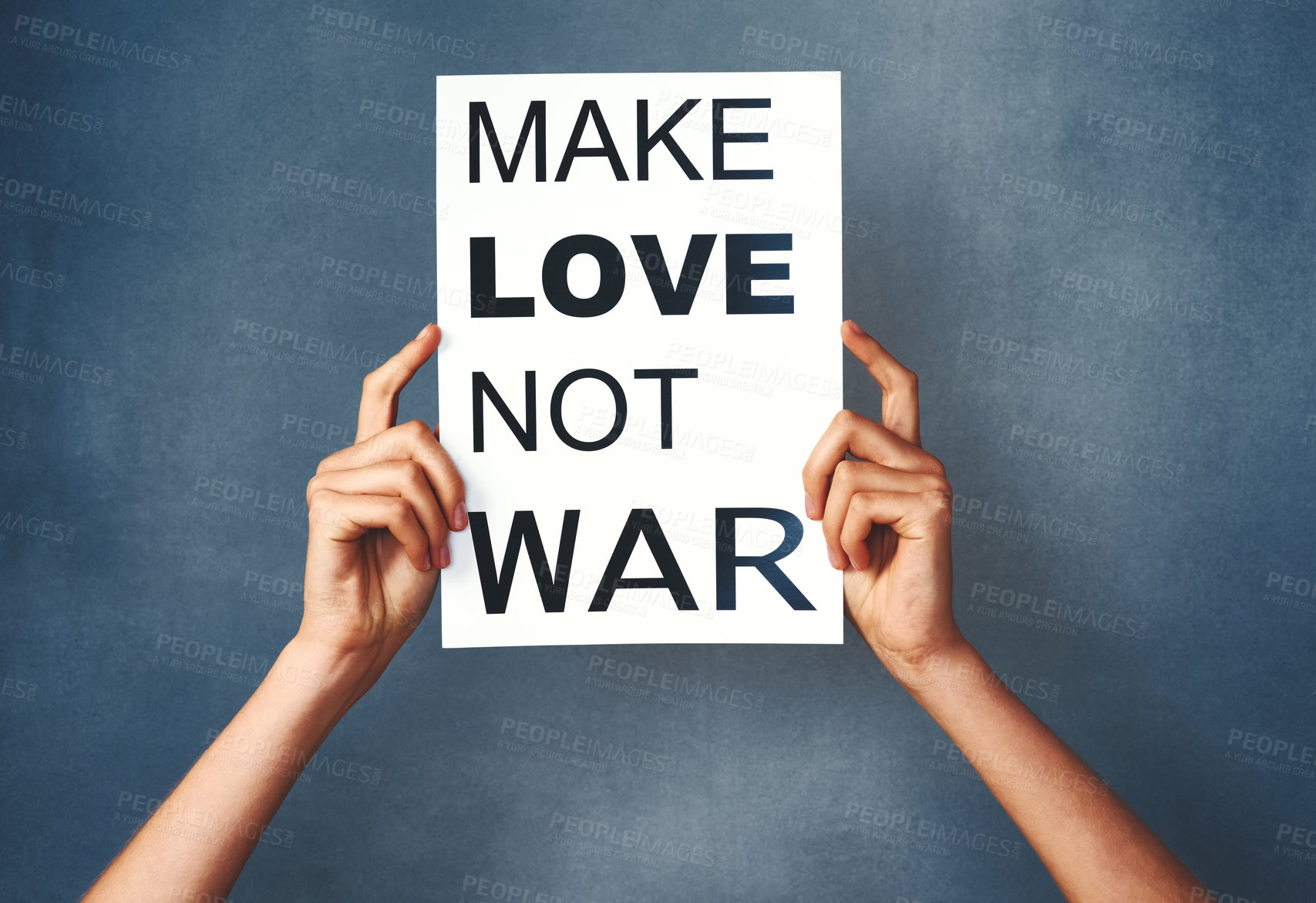Buy stock photo Studio shot of an woman holding a sign that says “make love not war” against a blue background