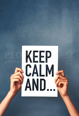 Buy stock photo Studio shot of an woman holding a sign that says “keep calm” against a blue background