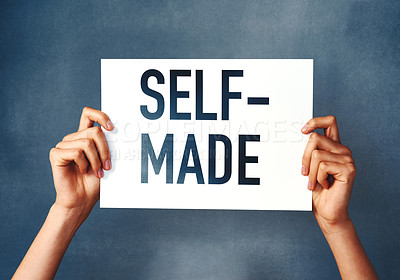 Buy stock photo Studio shot of an woman holding a sign that says “self made” against a blue background