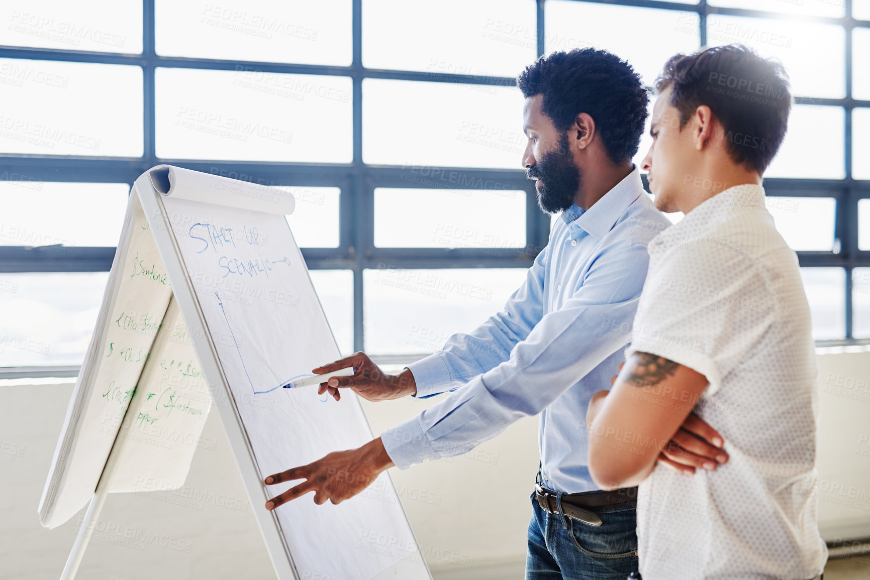 Buy stock photo Cropped shot of two businesspeople brainstorming together in an office