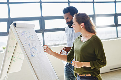 Buy stock photo Cropped shot of two businesspeople brainstorming together in an office