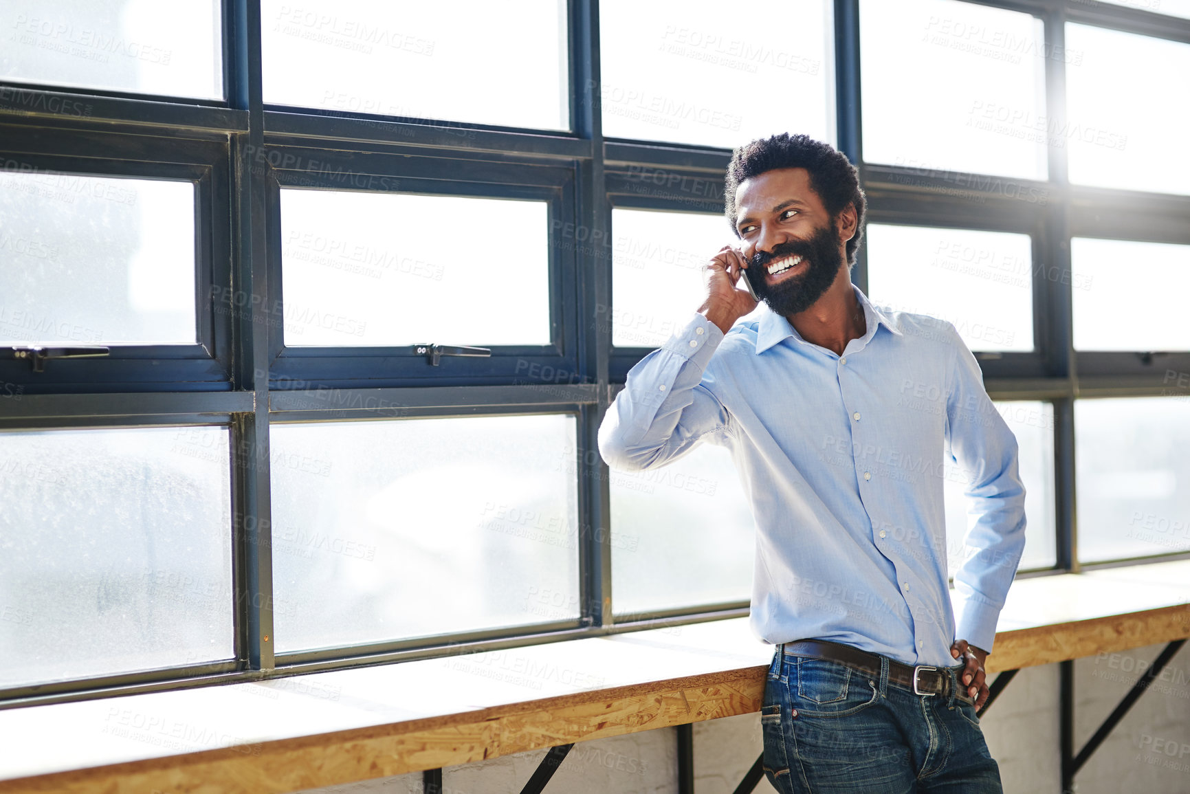 Buy stock photo Window, phone call and smile with a business man in the office for planning, communication or negotiation. Happy, thinking and mobile networking with a male employee in the workplace during his break