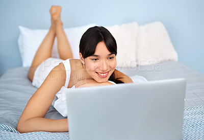 Buy stock photo Woman, laptop and smile with lying on bed for relax or streaming on internet with video. Bedroom, social media and technology with subscription for movie in pyjamas on website for enjoyment in house