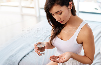 Buy stock photo Morning, bedroom and woman with water, pills or painkillers for period cramps, home or treatment for virus. Daily vitamins or protein with healthcare, tablets or medicine for disease, sick or illness