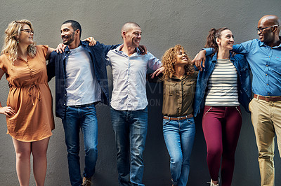 Buy stock photo Shot of a group of people standing together against a wall outside