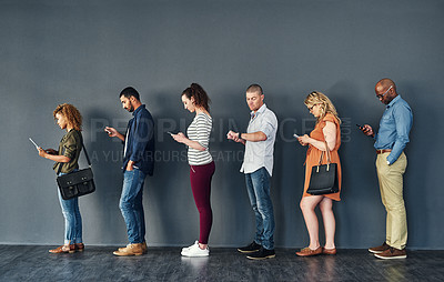 Buy stock photo Studio shot of people waiting in line against a grey background