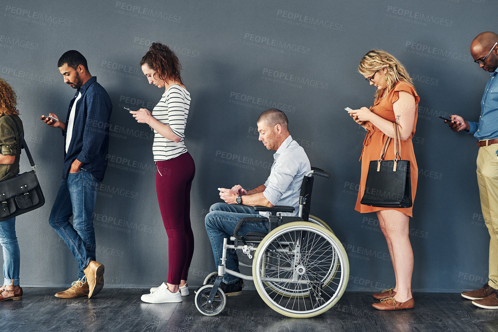 Buy stock photo Studio shot of a man in a wheelchair waiting in line against a grey background