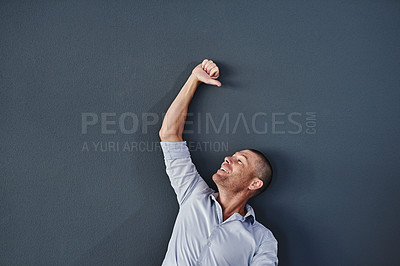 Buy stock photo Studio shot of a mature man raising his hand against a grey background