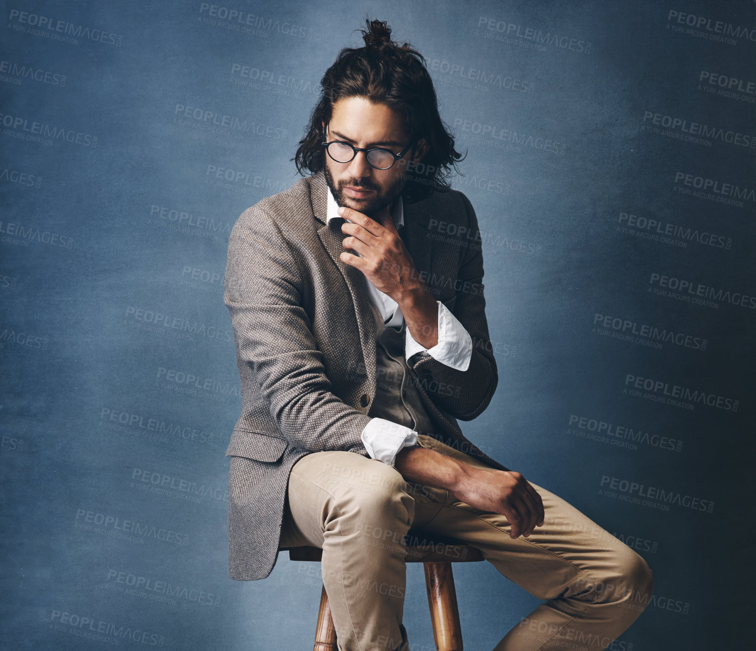 Buy stock photo Studio shot of a handsome young man looking thoughtful against a grey background