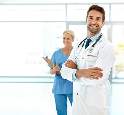 Buy stock photo Cropped portrait of two happy healthcare practitioners posing together in a hospital