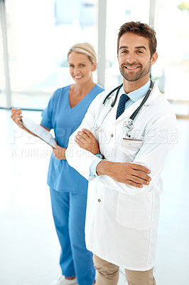 Buy stock photo Cropped portrait of two happy healthcare practitioners posing together in a hospital