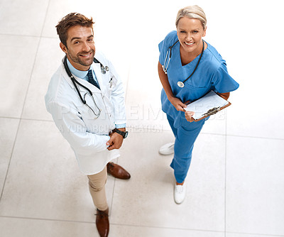 Buy stock photo High angle portrait of two happy healthcare practitioners posing together in a hospital