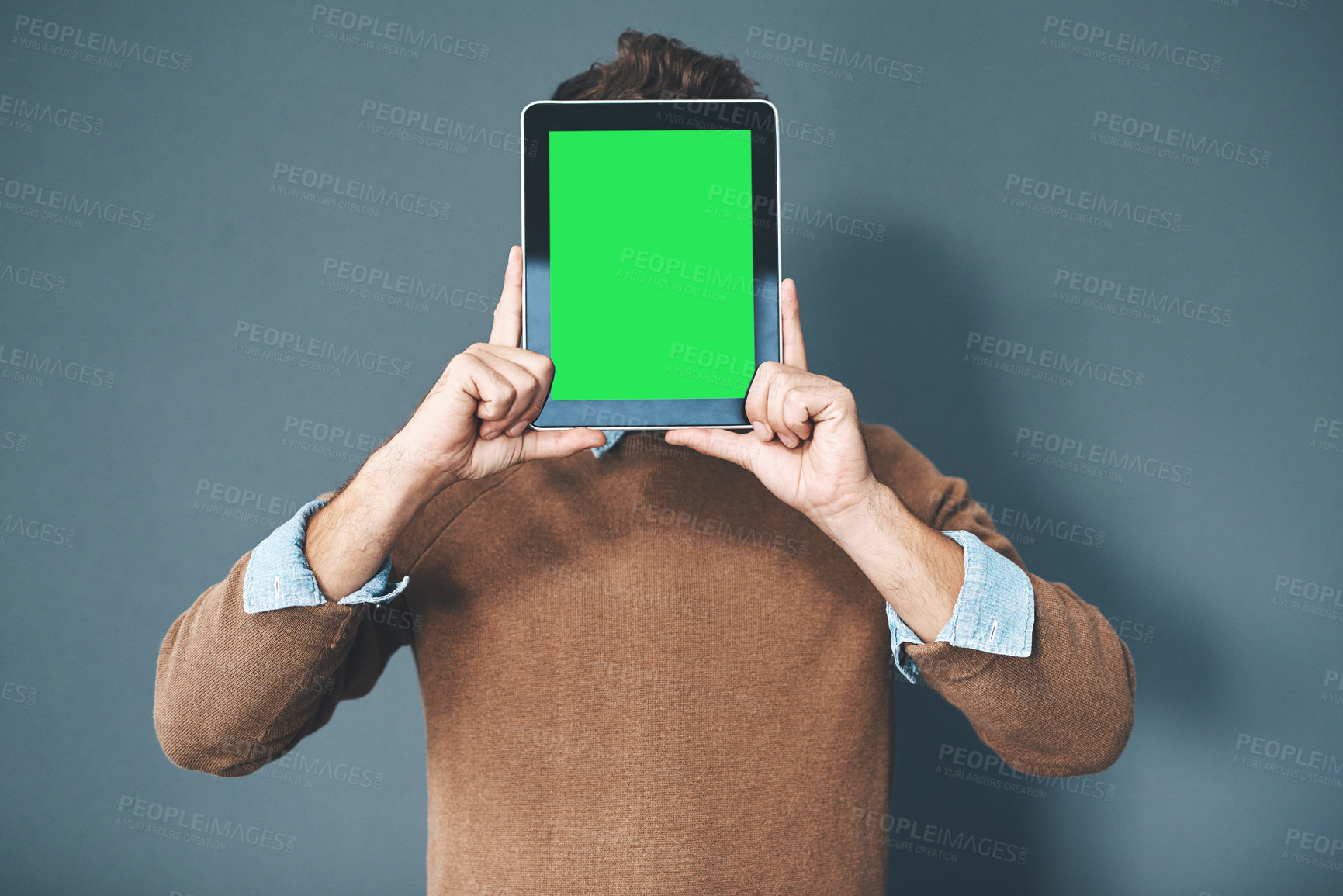 Buy stock photo Tablet with green screen, chroma key and copy space held by man against grey background. Technology and advertising or marketing of a digital business at a workplace. Creativity online and innovation