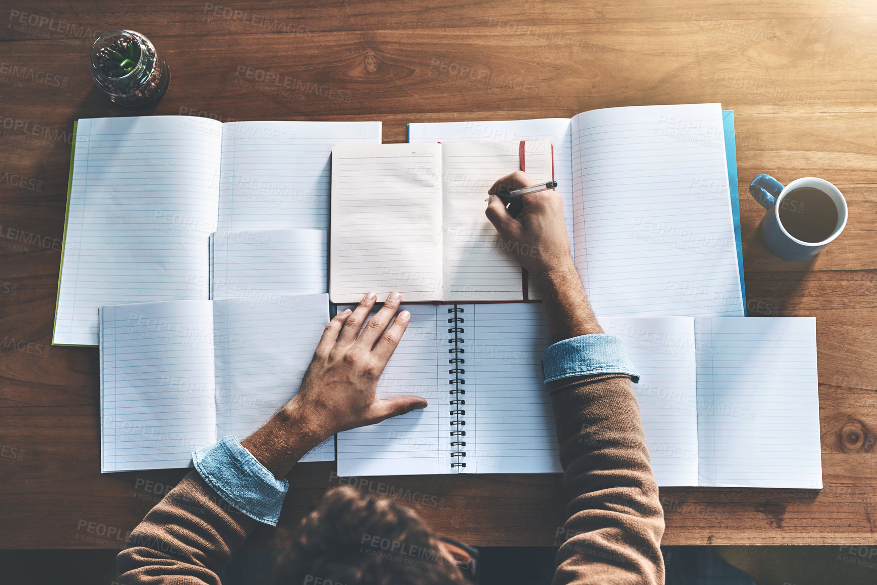 Buy stock photo Man, above and hands for writing in books, author brainstorming and planning novel plot or theme. Male person, coffee and notes on character arc in home office, inspiration and editing rough draft