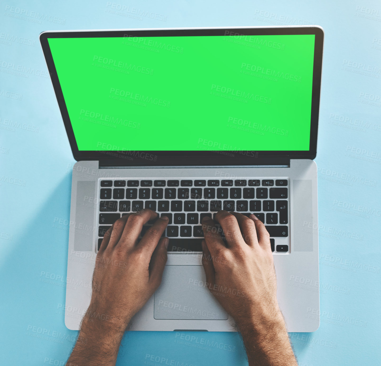 Buy stock photo Studio shot of a man typing on a laptop with a green screen against a green background