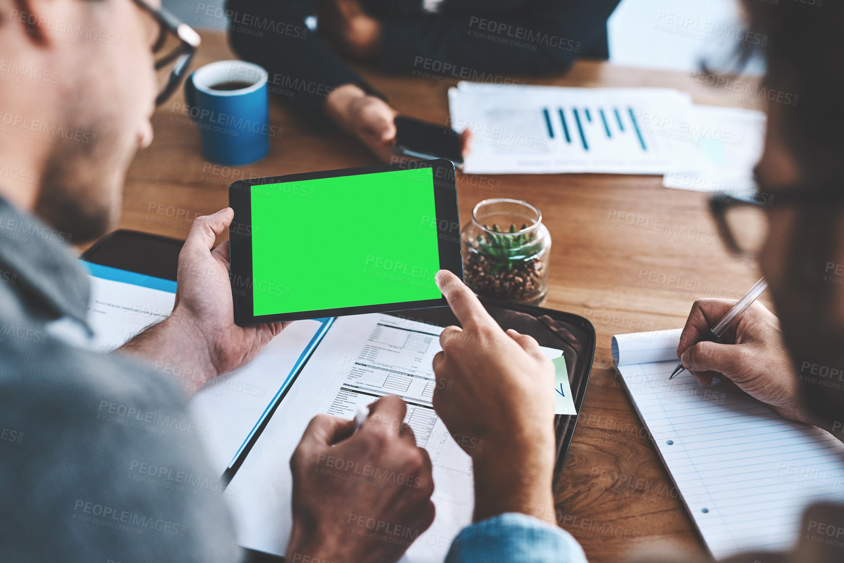 Buy stock photo Green screen, copyspace and chromakey on a tablet screen in the hands of a business man in a meeting in a boardroom. Advertising, marketing and online promotion with colleagues pointing at copyspace