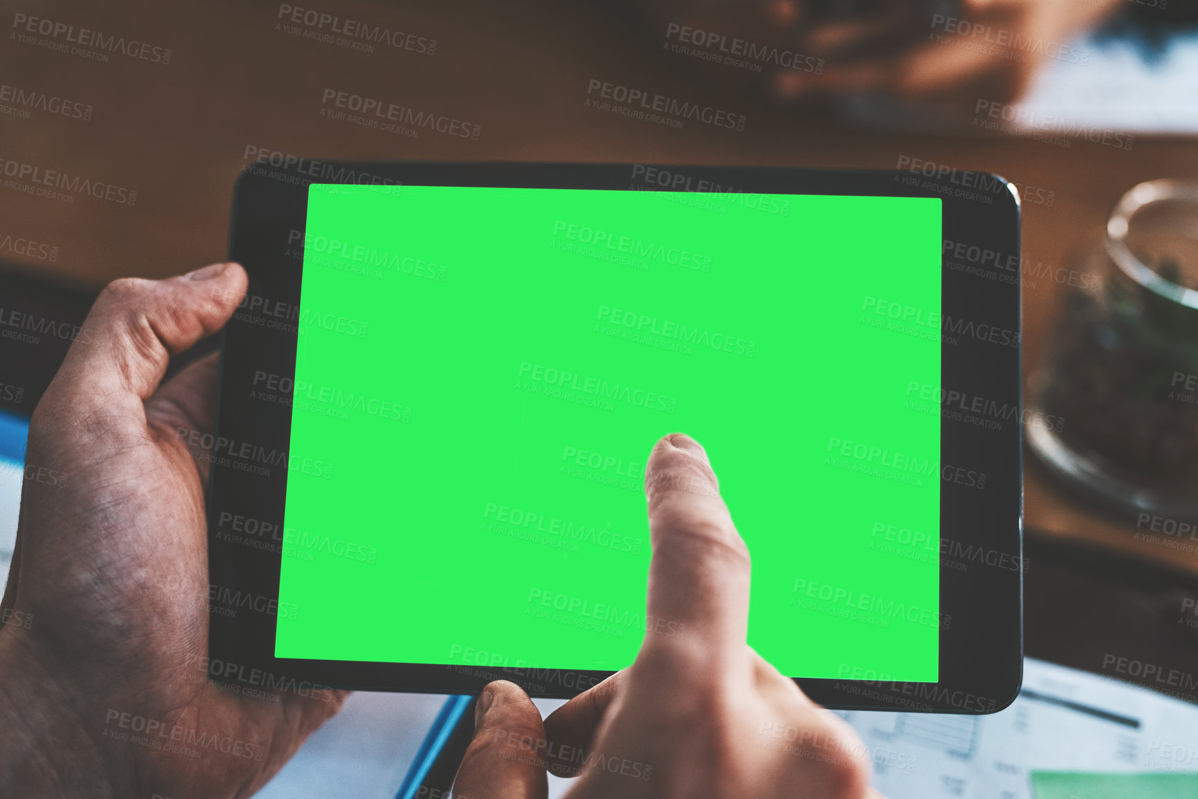 Buy stock photo Cropped shot of a businessman using a digital tablet with a green screen during a meeting at work