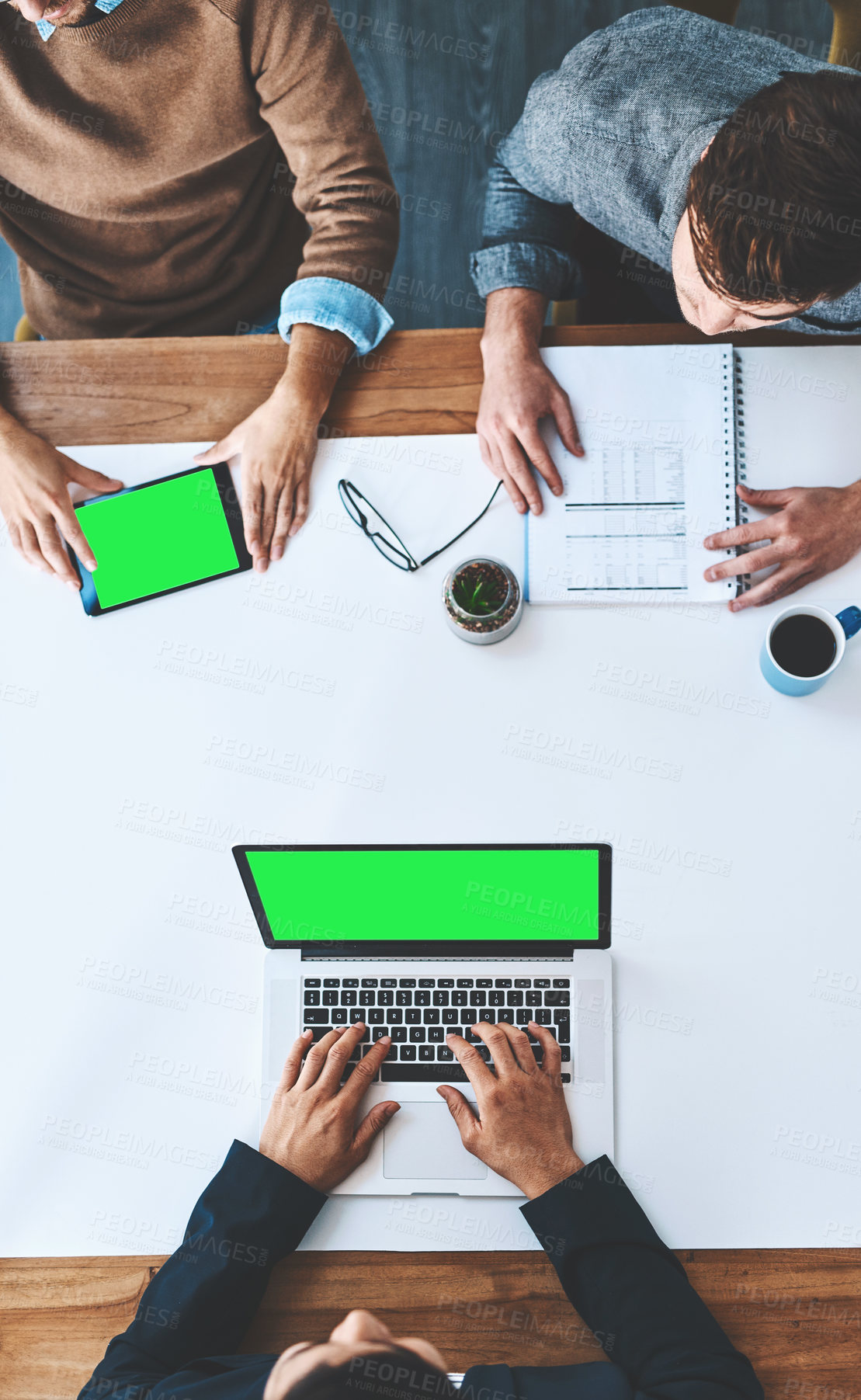 Buy stock photo Green screen, copyspace and chromakey on the screen of a laptop and tablet in an office from above. Business people in a meeting, discussing marketing and advertising strategy in the boardroom