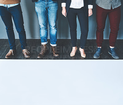Buy stock photo Studio shot of a group of unrecognisable people standing in a row against a grey background