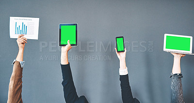 Buy stock photo Cropped studio shot of a group of businesspeople holding wireless devices against a gray background