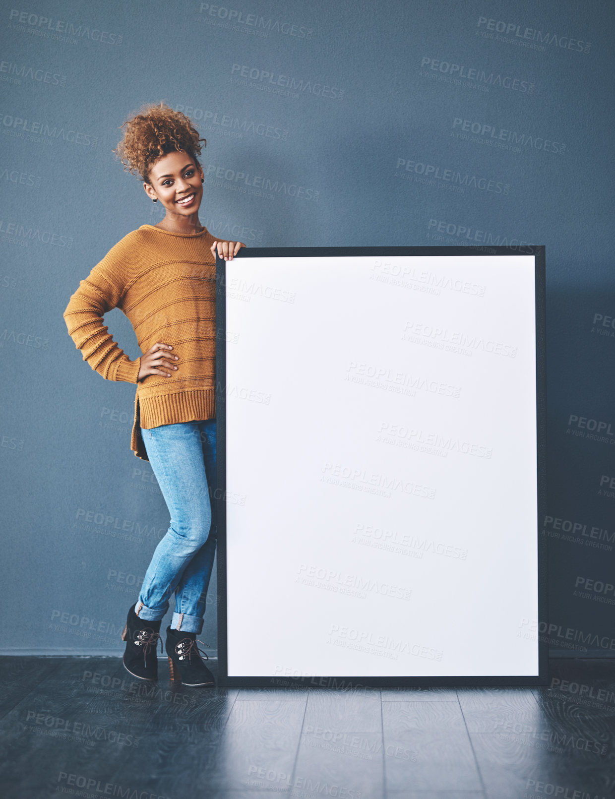 Buy stock photo Studio shot of a young woman posing with a blank sign against a grey background