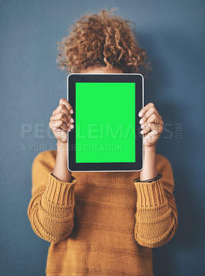 Buy stock photo Studio shot of a young woman holding a digital tablet with a green screen against a grey background