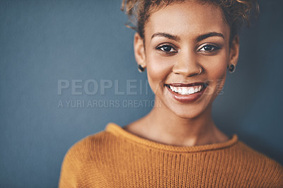 Buy stock photo Studio portrait of an attractive young woman standing against a grey background