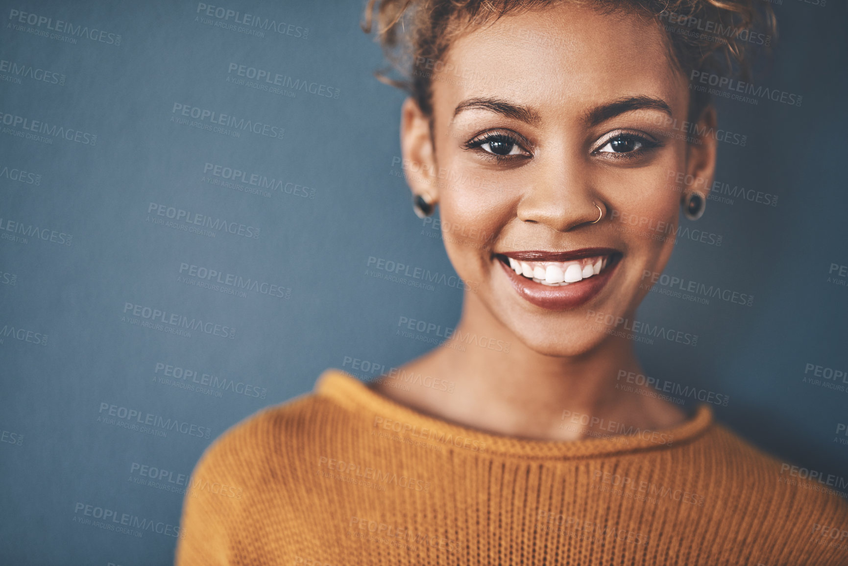 Buy stock photo Portrait, smile and woman with piercings in studio for alternative fashion, style and confidence. Happy, positive and person face by mockup space with cosmetic, makeup or jewellery on blue background