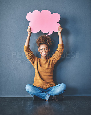 Buy stock photo Studio shot of a young woman holding a thought bubble against a grey background