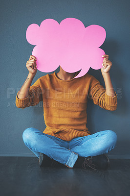 Buy stock photo Studio shot of a young woman holding a thought bubble against a grey background
