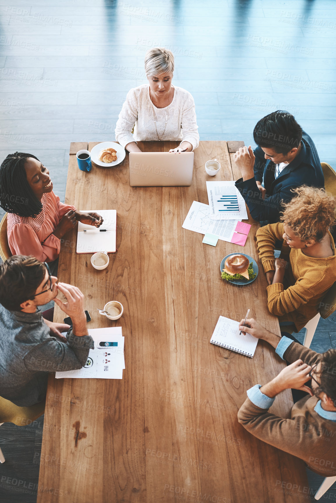 Buy stock photo Shot of a group of young businesspeople having a meeting in a modern office