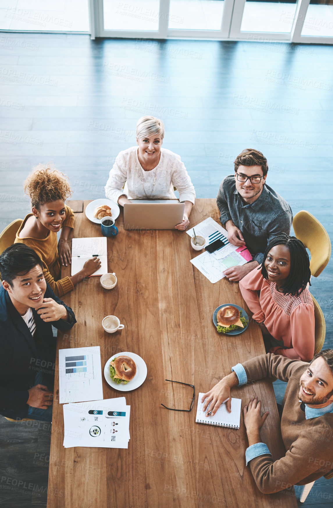 Buy stock photo Shot of a group of young businesspeople having a meeting in a modern office