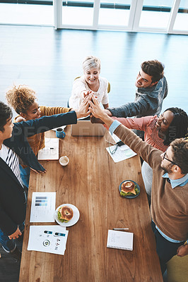 Buy stock photo Diverse group of businesspeople high five after planning a meeting in an office. Above ambitious happy confident professional team of colleagues celebrating a success, achievement and feeling excited