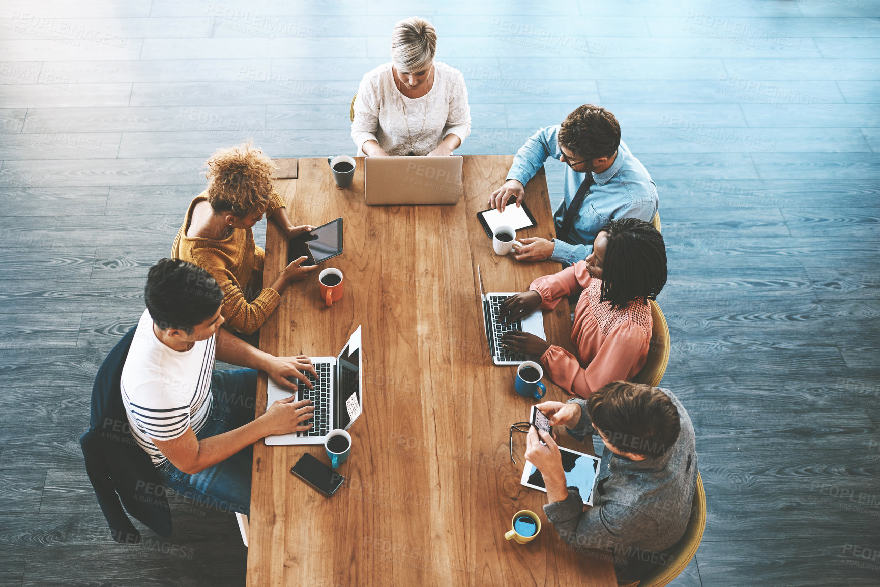 Buy stock photo Innovation, digital marketing and planning online with laptop and tablet while creative team sit together at a table from above. Group of designers doing research or building social media network 