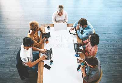 Buy stock photo Colleagues planning, discussing strategy and searching online. Diverse business people talking in meeting, typing on laptops and browsing on tablet for ideas together in an office at work from above