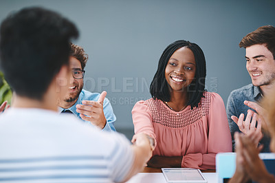 Buy stock photo Shot of a colleagues shaking hands during a meeting in a modern office
