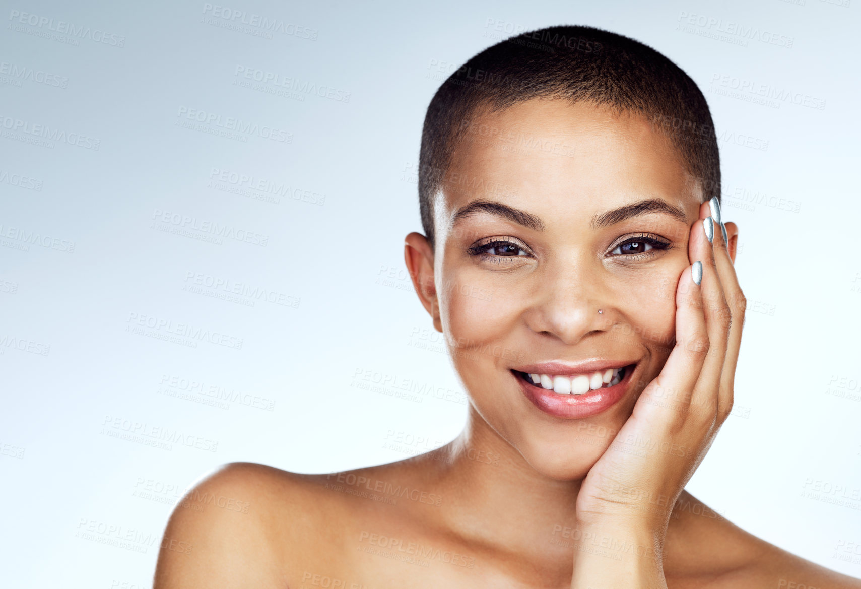 Buy stock photo Shot of a beautiful young woman touching her face against a grey background