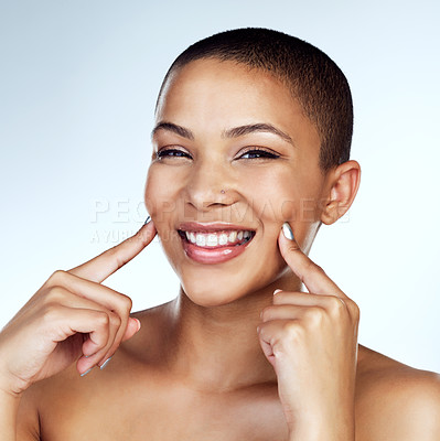 Buy stock photo Studio shot of a beautiful young woman posing with her fingers on her cheeks