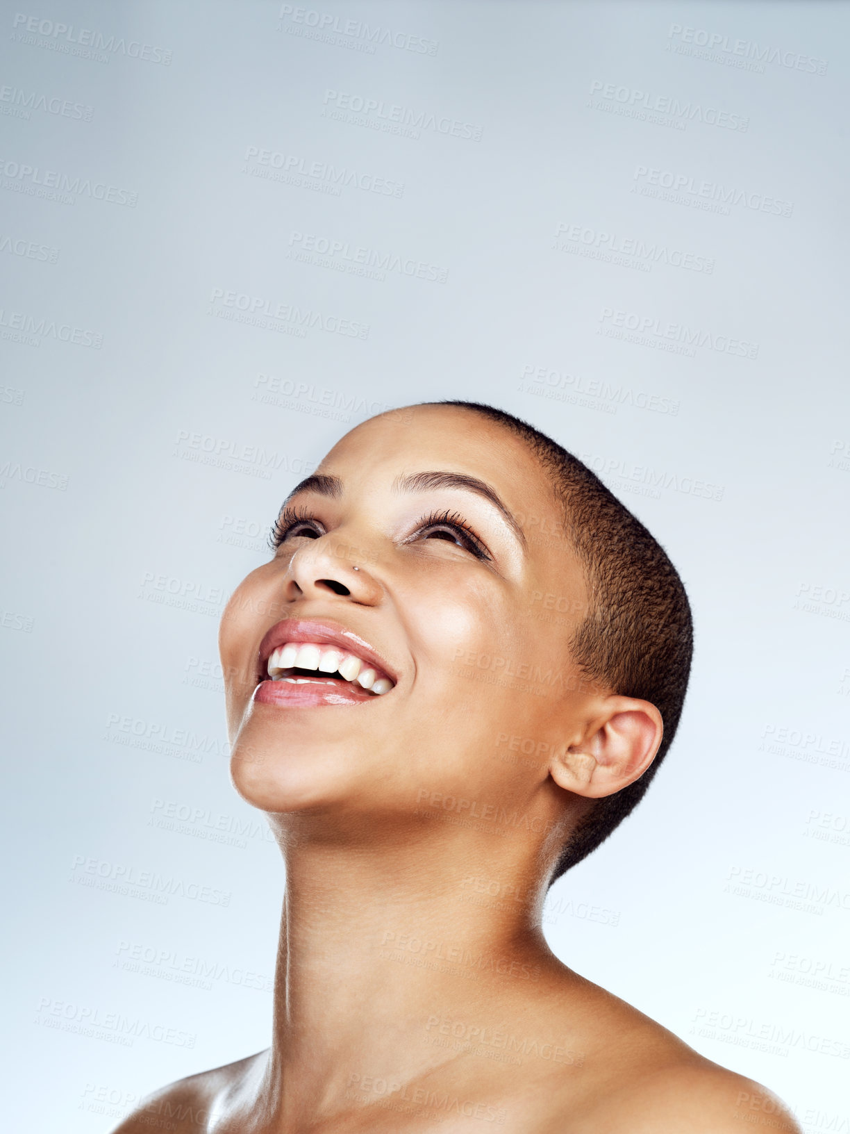 Buy stock photo Studio shot of a beautiful young woman smiling against a grey background